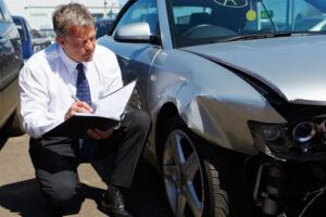 Car Accident Lawyer Monticello, IN - insurance adjuster evaluating car damage